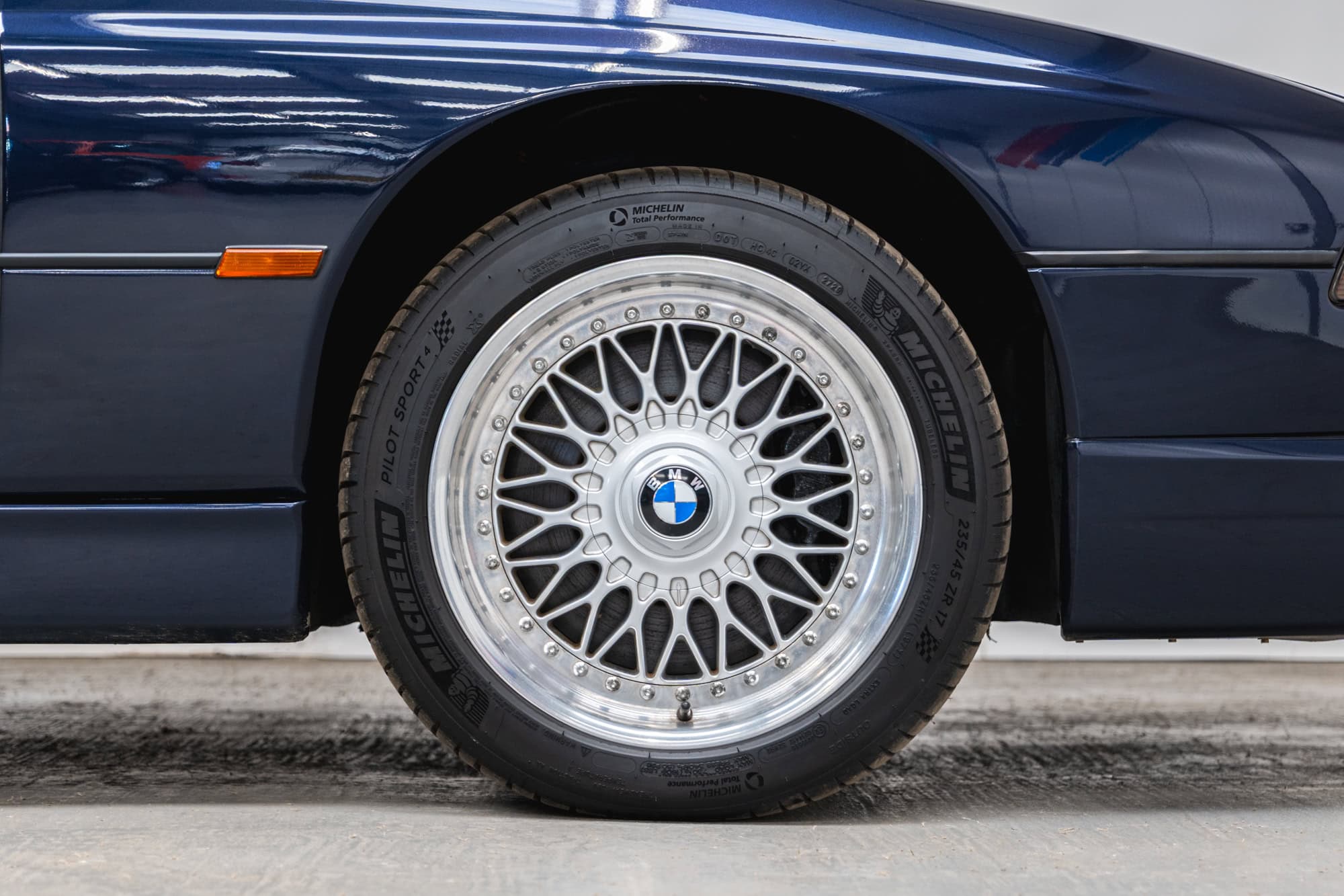 Close up of a BMW 850 CSI coupe in orient blue metallic BBS split rim alloy wheels.
