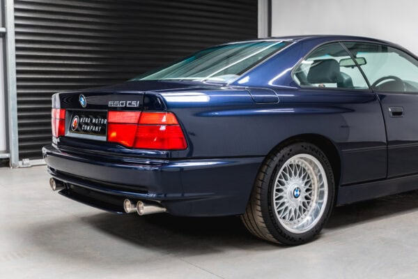 Offside rear quarter view of a BMW 850 CSI coupe in orient blue metallic on BBS split rim alloy wheels.