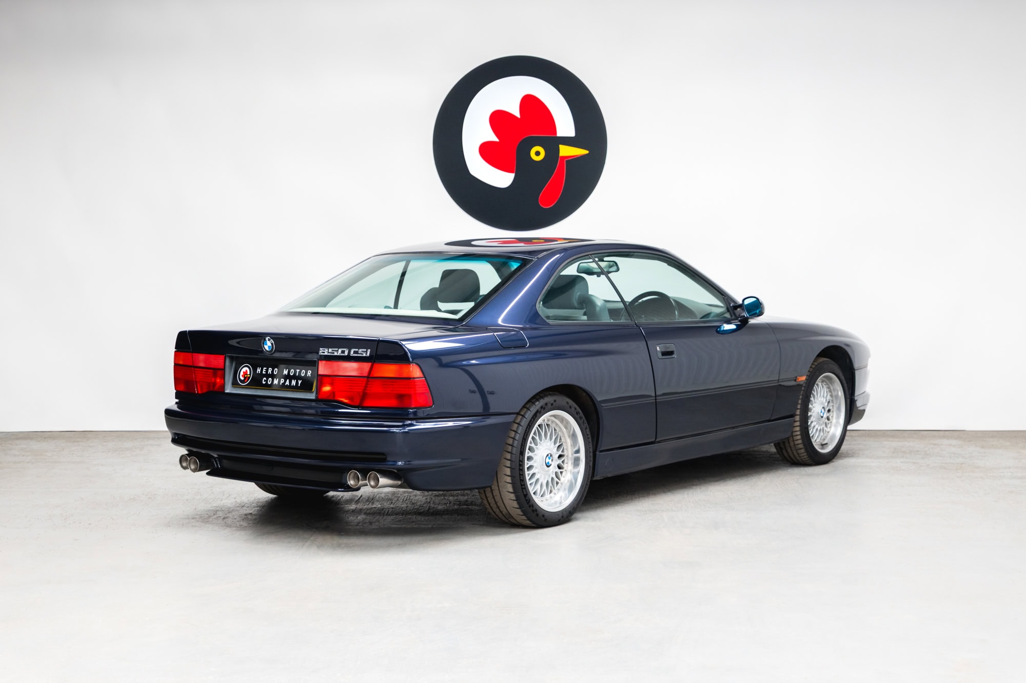 Offside rear quarter view of a BMW 850 CSI coupe in orient blue metallic on BBS split rim alloy wheels.